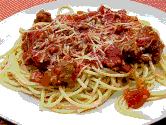 Spaghetti pasta with a tomato and hamburger meat sauce with parmesan cheese grated on top.