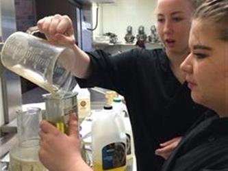 Students mixing ingredients in a kitchen